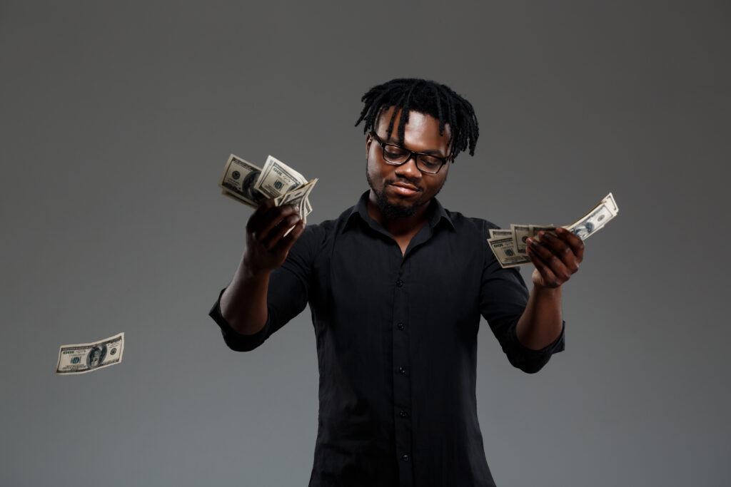 Joven empresario africano exitoso lanzando dinero